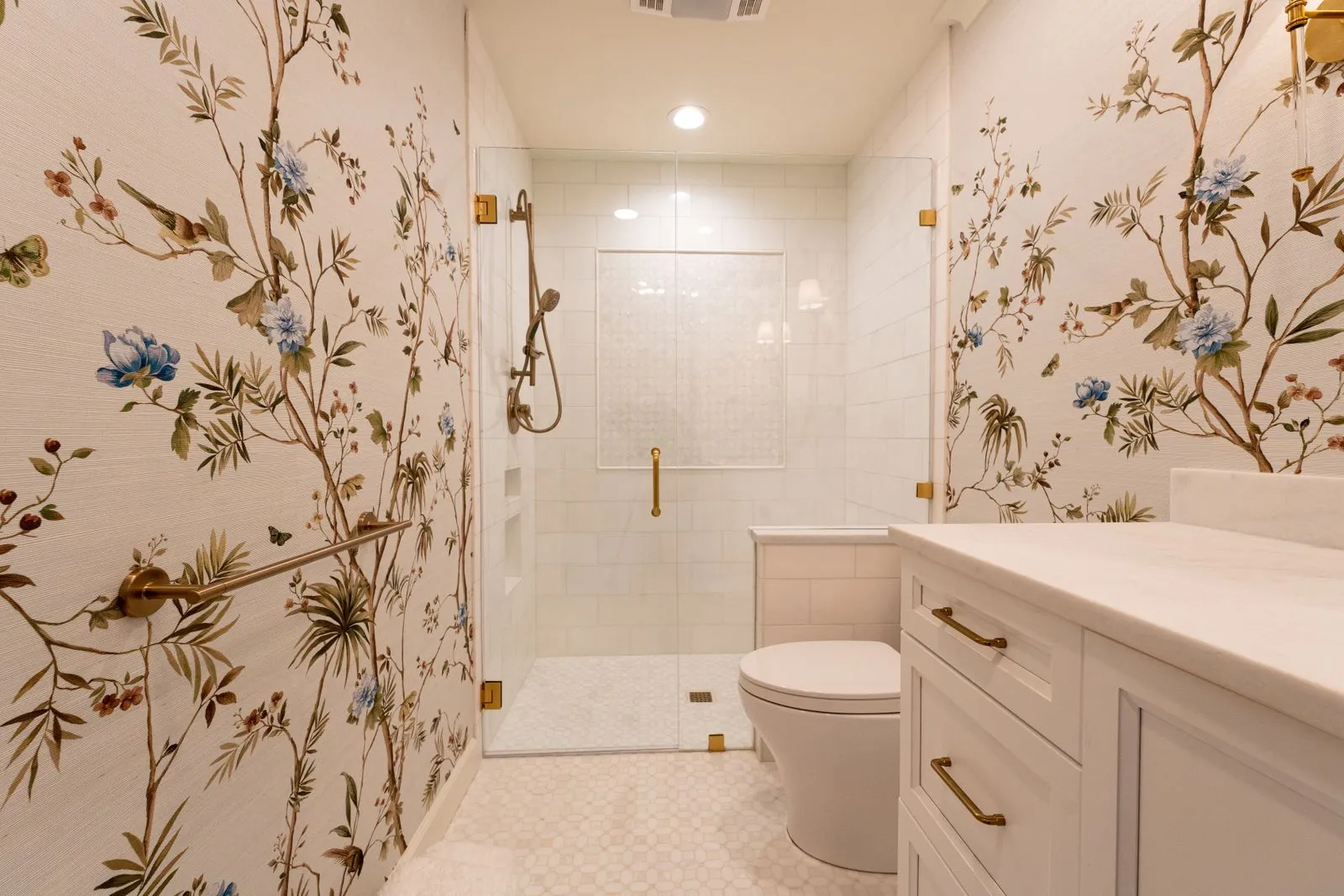 Accessible bathroom with grab bars and a curbless walk-in shower
