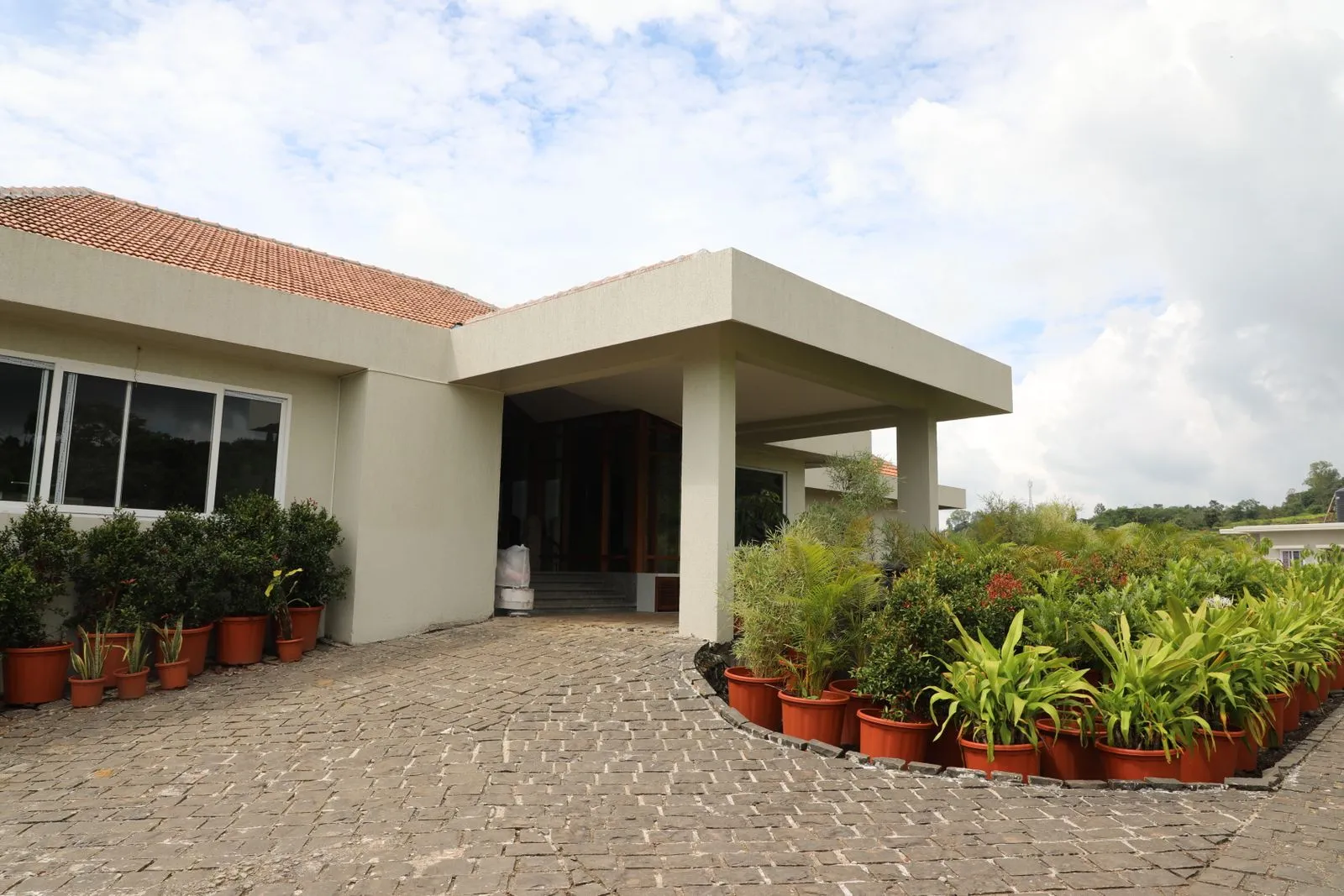 Covered portico entrance with seating and flower planters