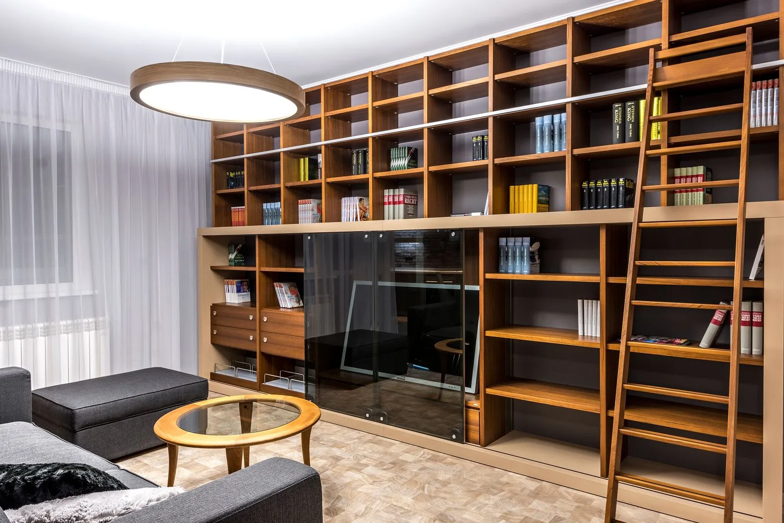 Cozy library nook with bookshelves and reading chairs by a window